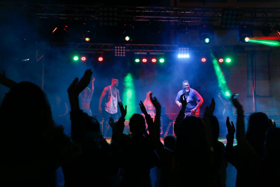 Crowd enjoying live music and dancing at a vibrant nightclub concert
